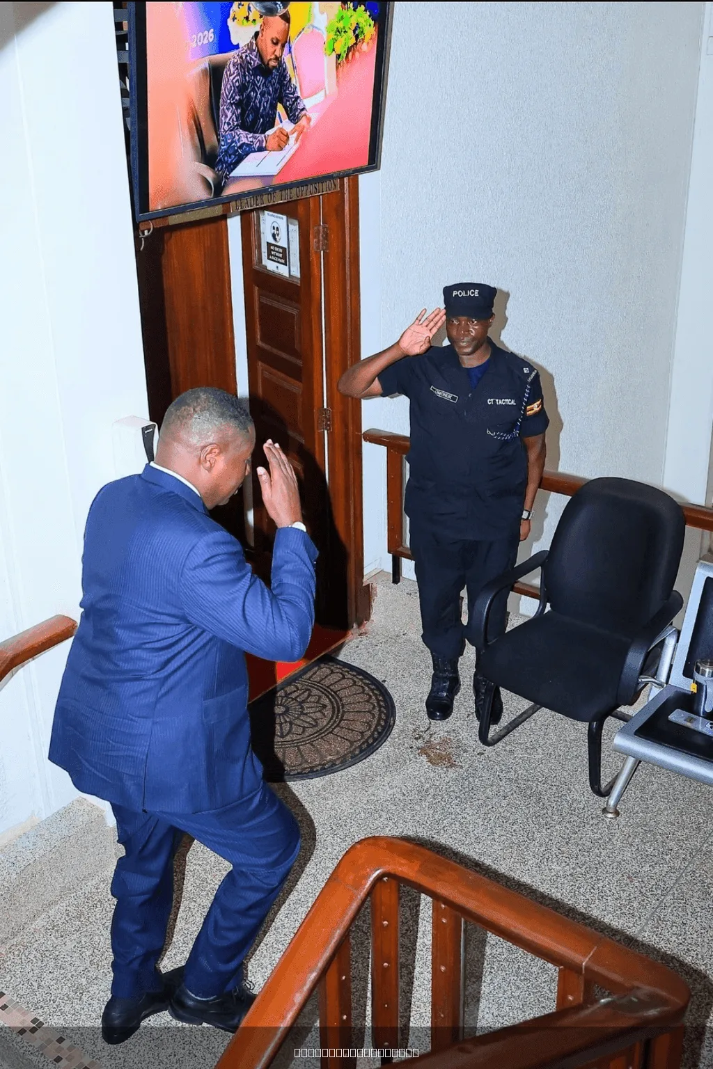 A police officer on guard at the Office of the Leader of Opposition, salutes the Speaker @ObothOboth — image 1